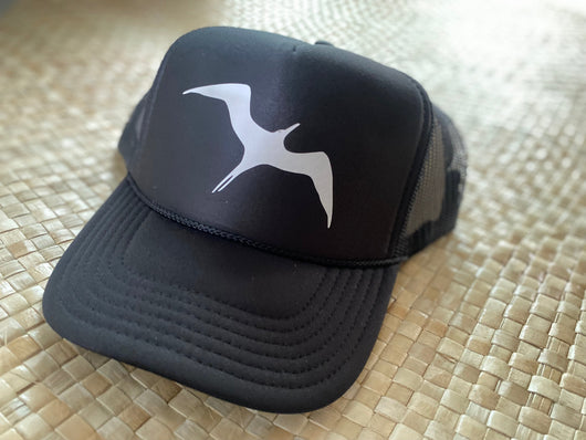 This hat is an Otto Brand trucker hat that is black with a white 'iwa bird or great frigate bird in the center of the cap. 